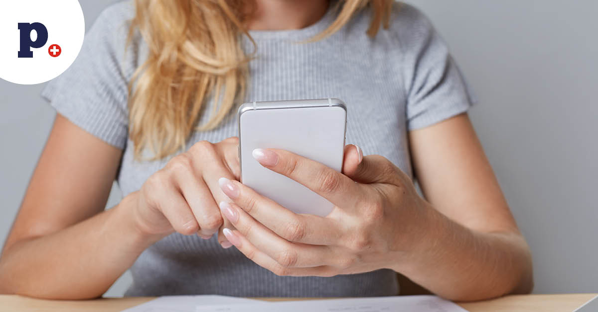 kobieta trzymająca smartfon nad fakturami